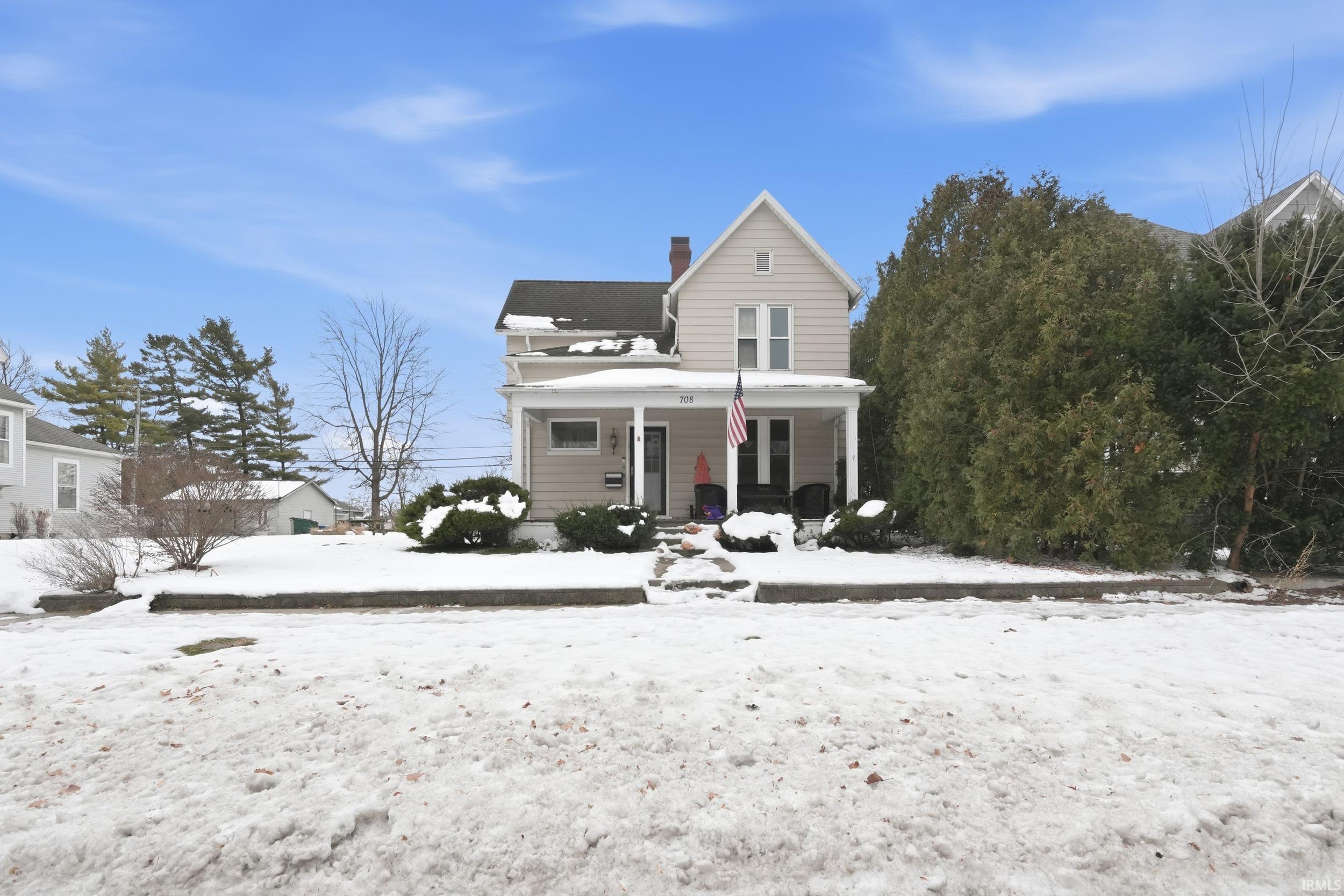 Image 0: View of front of house with a porch and a chimney, Front Of Structure