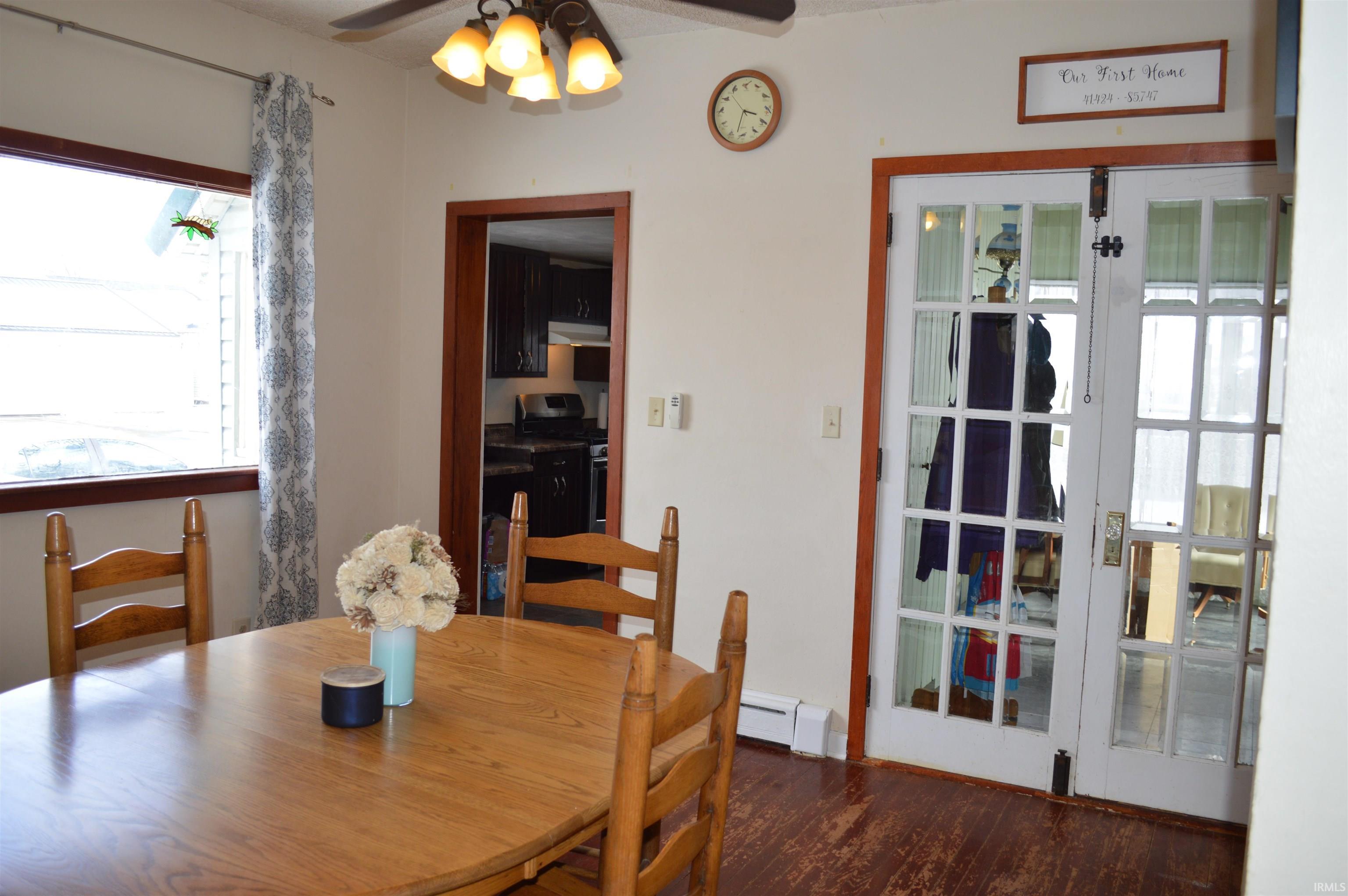 Image 2: Dining room featuring dark wood-style floors, a ceiling fan, and a baseboard radiator, Dining Area
