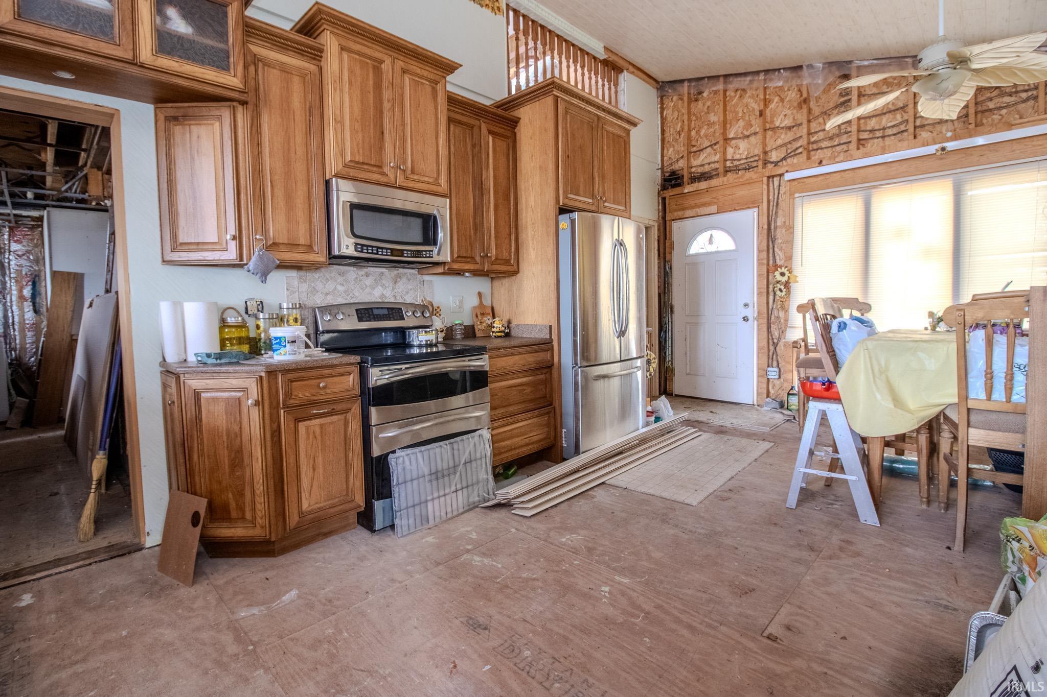 Image 2: Kitchen featuring wood finish cabinetry, stainless steel appliances, and a ceiling fan, Kitchen