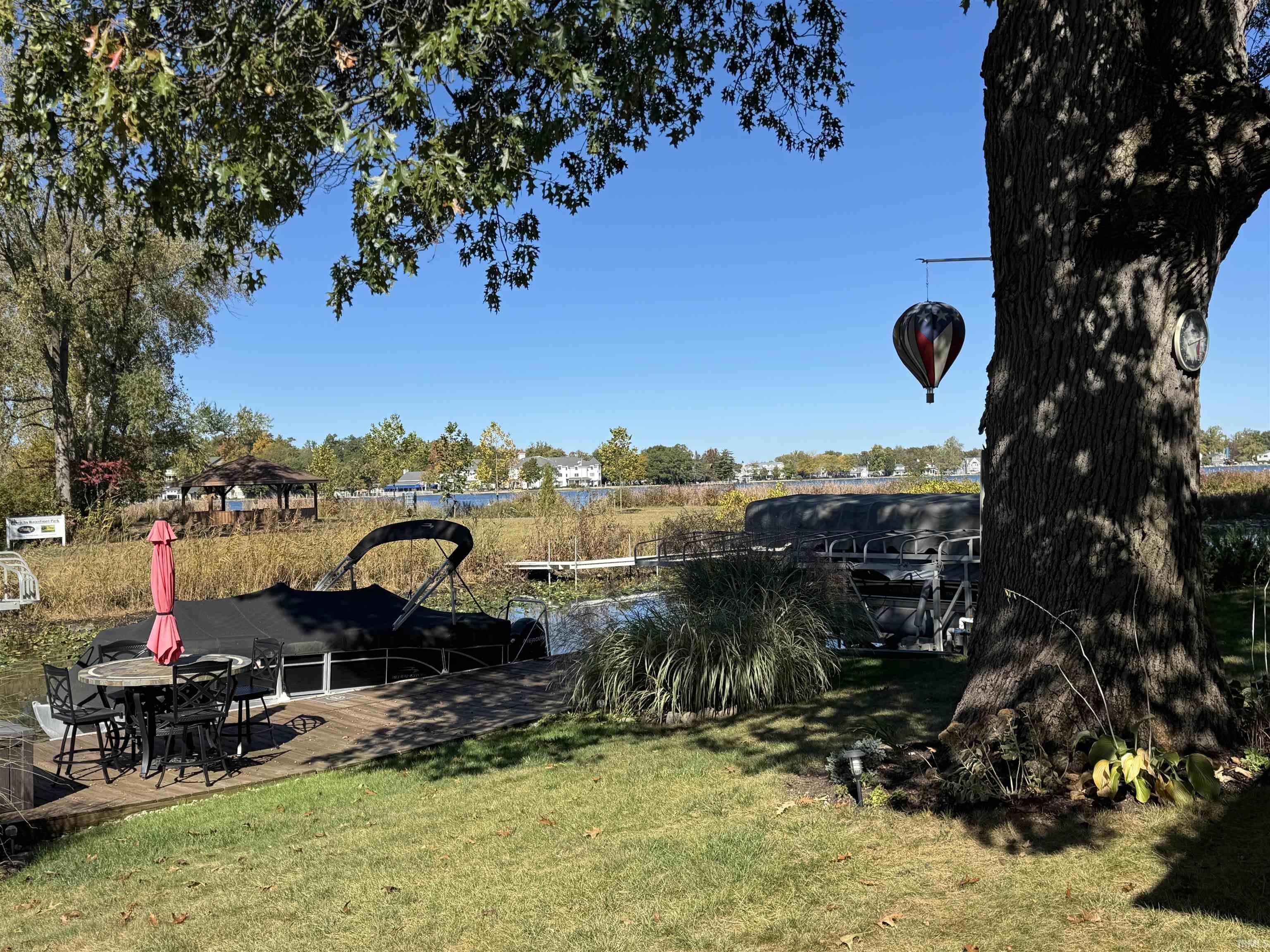 Image 3: View of grassy yard featuring a pier and a boat dock., View - Front Yard Image 3: View of grassy yard featuring a pier and a boat dock., View - Front Yard