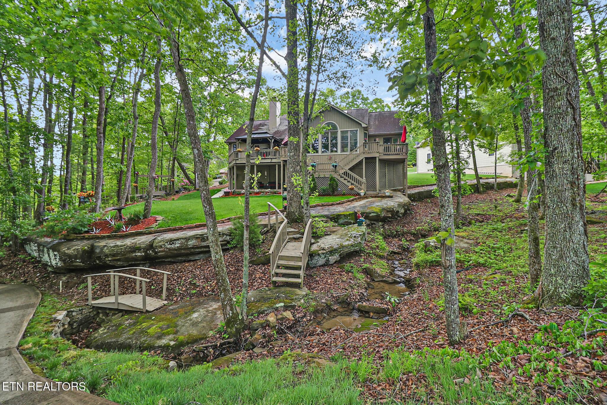Image 4: Back of home- beautiful landscaping