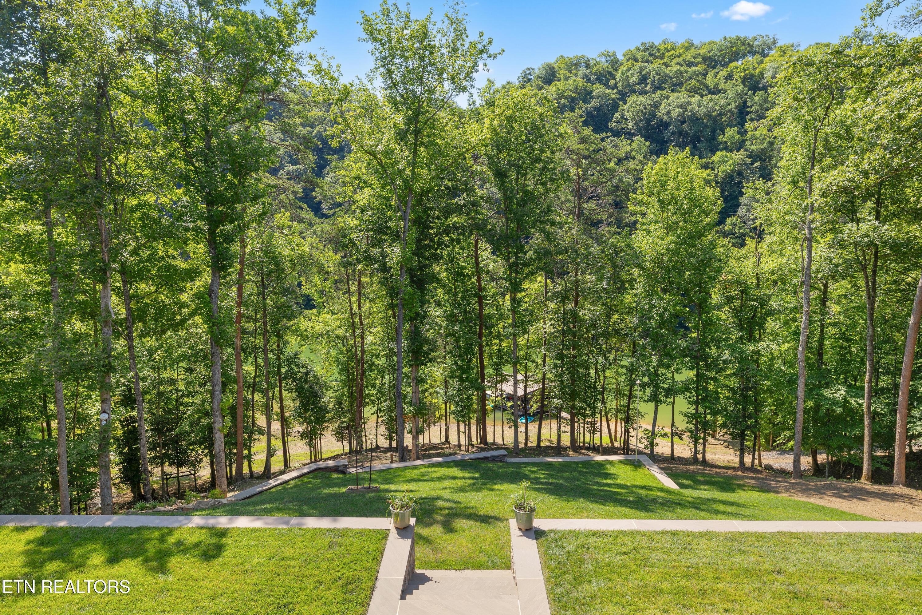 Image 3: Well manicured lake side of home