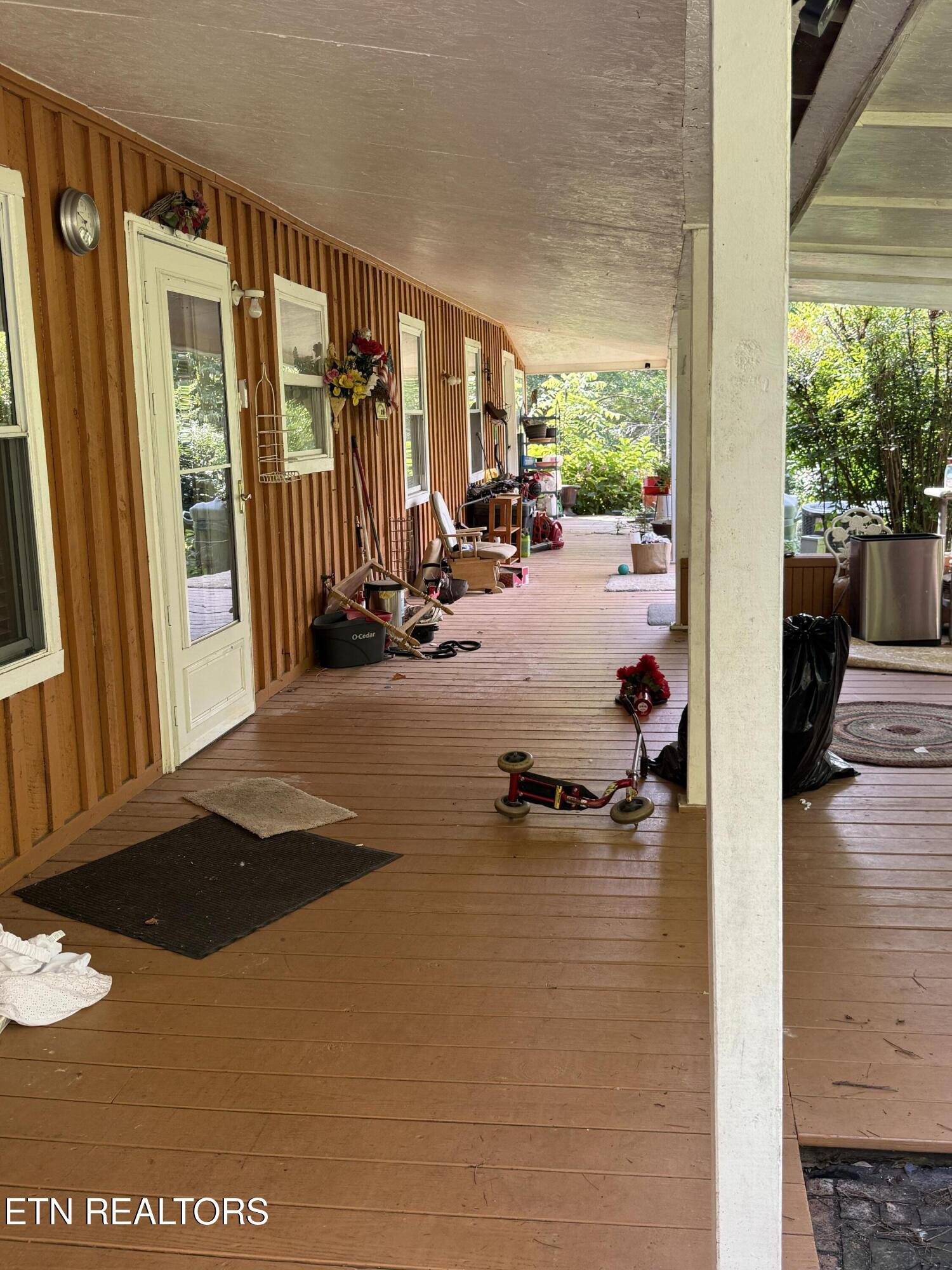 Image 2: Inviting back porch with serene garden v