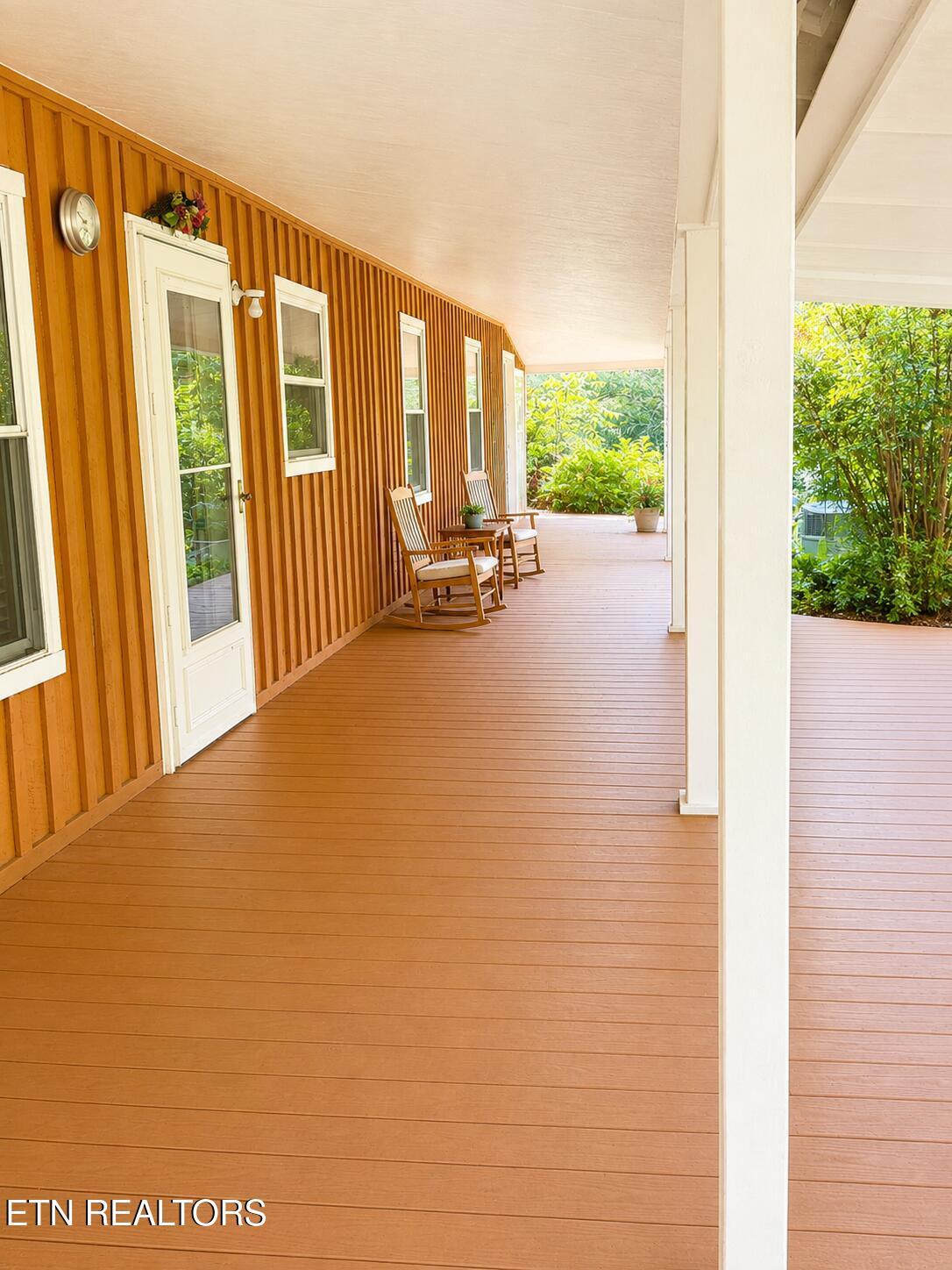 Image 3: Inviting porch with serene garden view