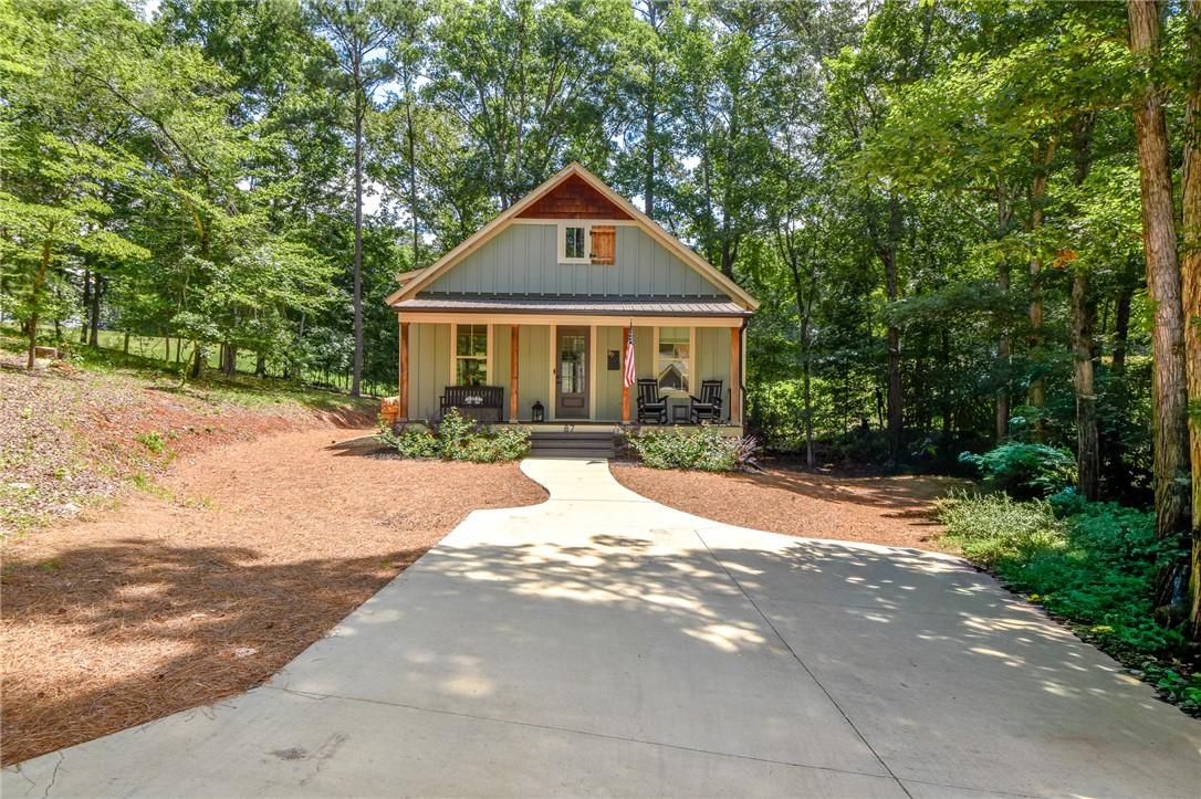 Image 2: A charming home nestled amongst dense trees, featu