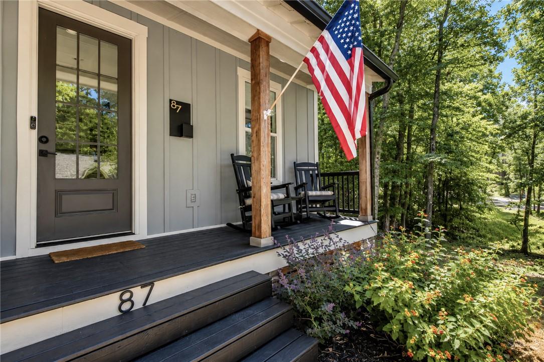 Image 3: A welcoming front porch beckons with rocking chair