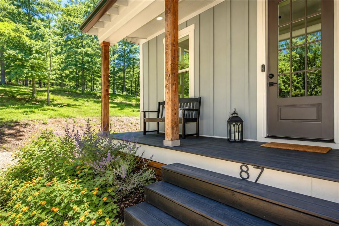 Image 4: A tranquil front porch with wooden columns offers