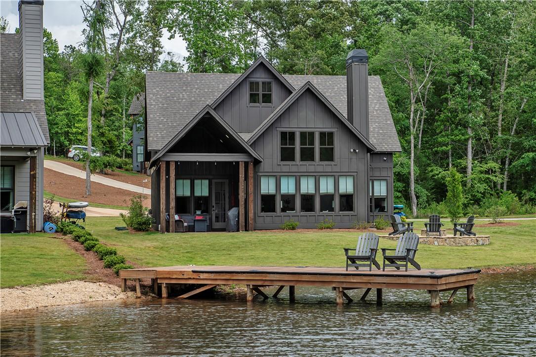 Image 2: This charming lakeside dwelling features a private