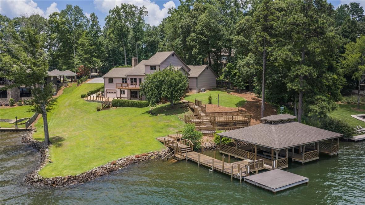 Image 1: Lakeside living offers a double boat house with li