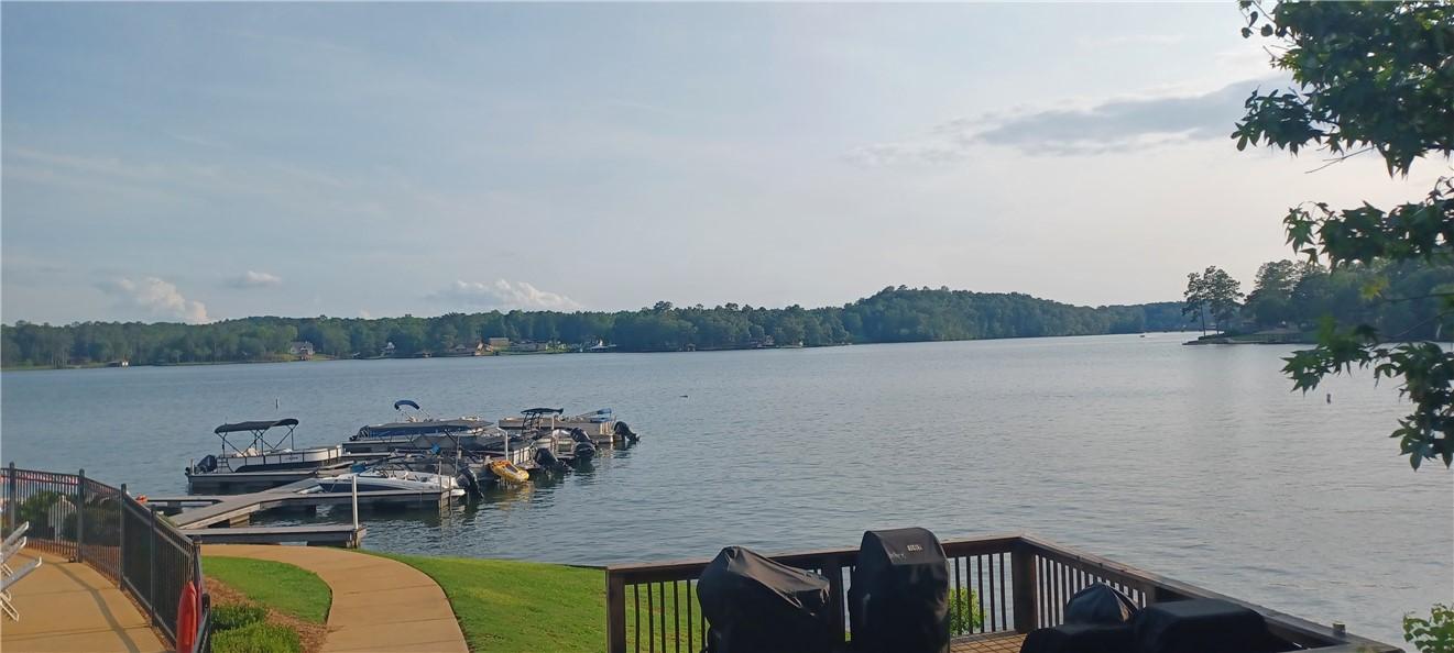Image 3: A tranquil lake view from a spacious wooden deck,