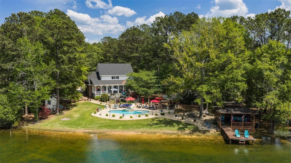 Image 1: This exquisite lakeside home offers a private pool