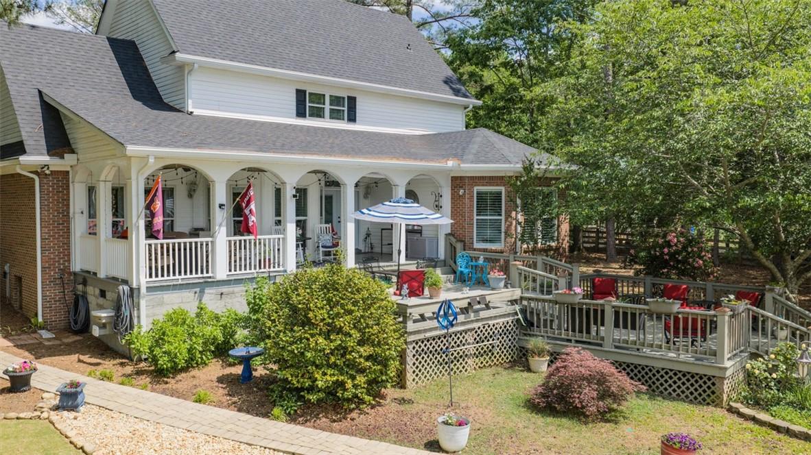Image 2: This charming residence features a spacious porch