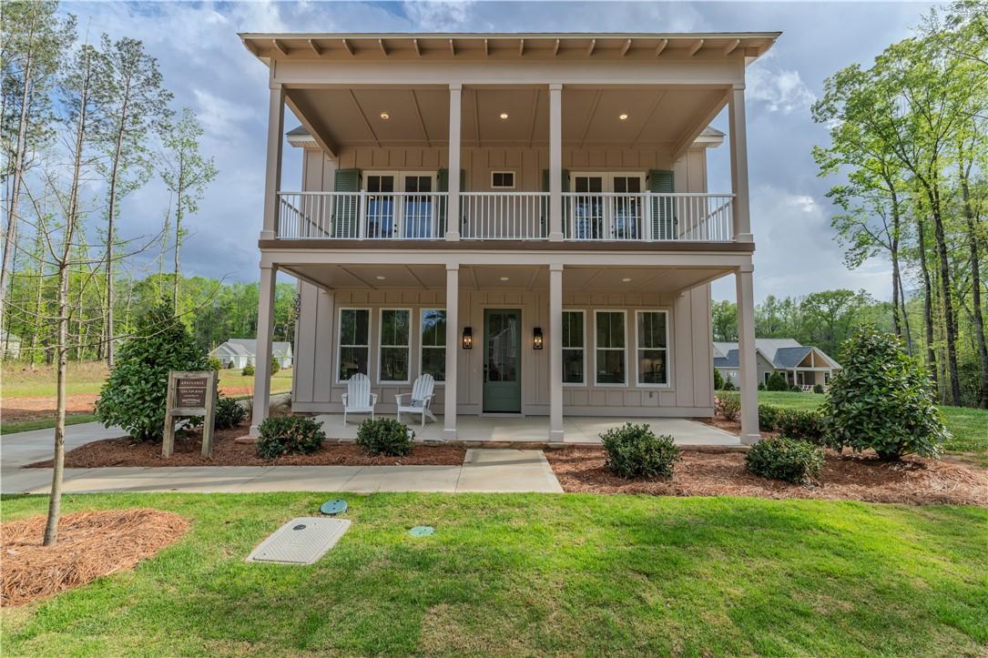 Image 1: This two-story Aspen Eagle Model presents a charmi