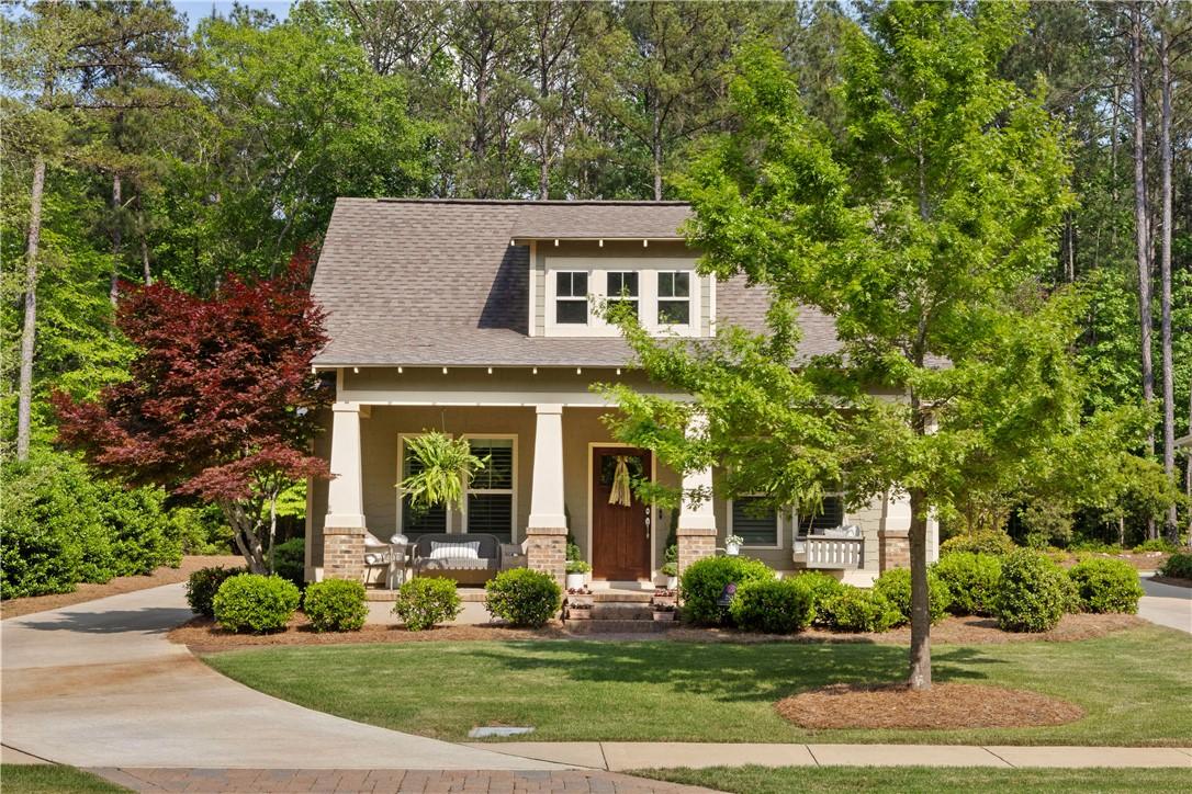 Image 1: A charming cottage-style residence nestled among m
