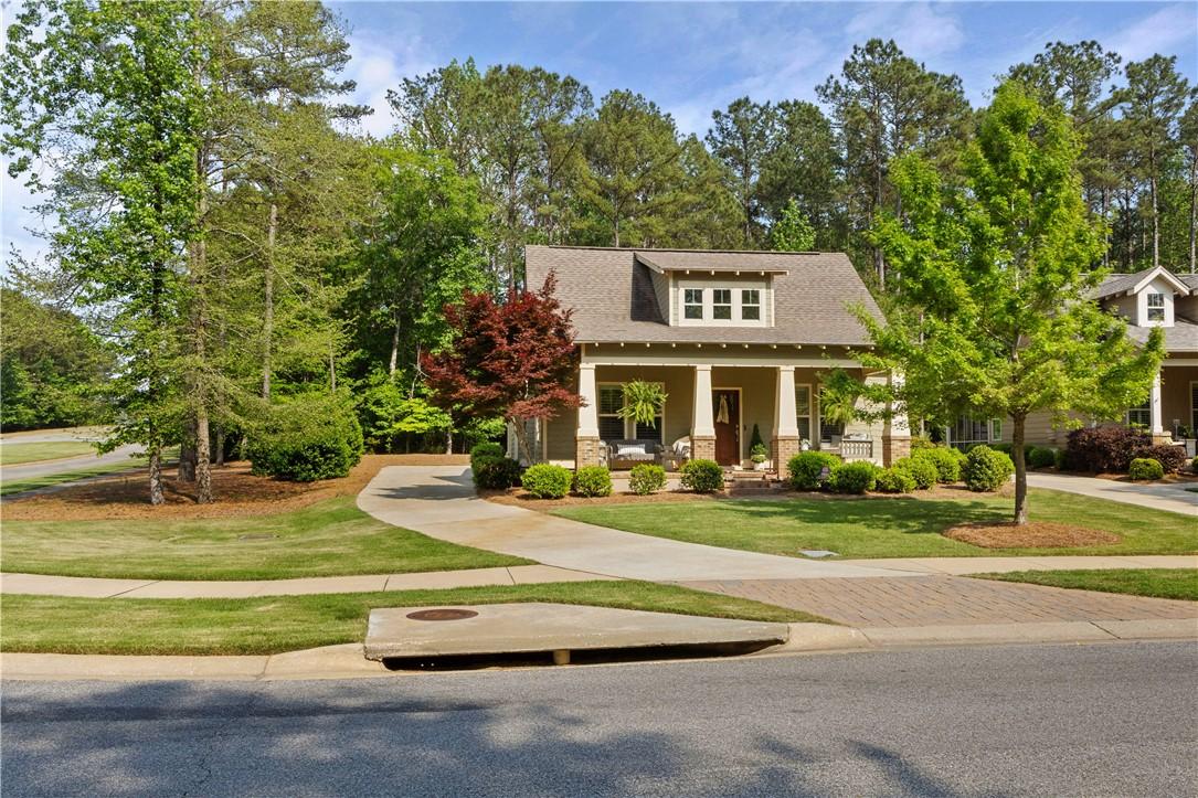 Image 2: A welcoming front porch and manicured lawn invite