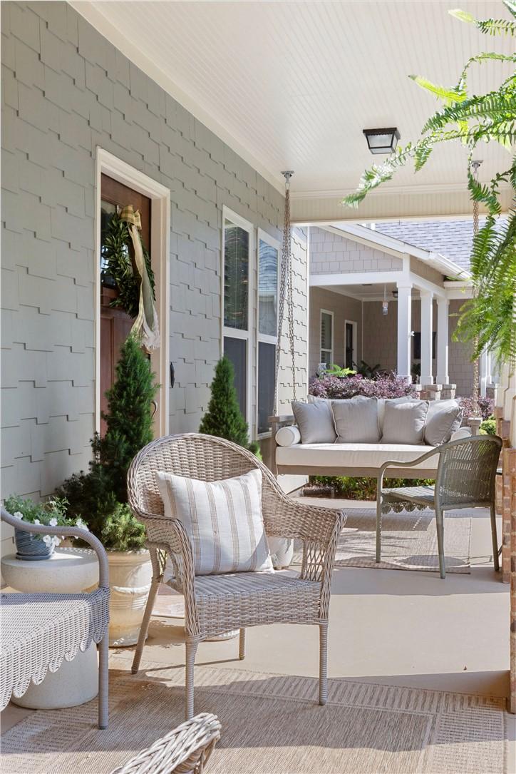 Image 3: A welcoming front porch beckons with a comfortable