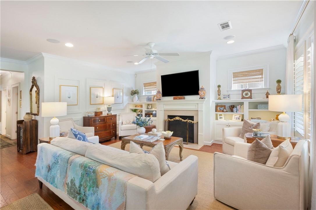 Image 4: Hardwood floors and built-in shelving complement t