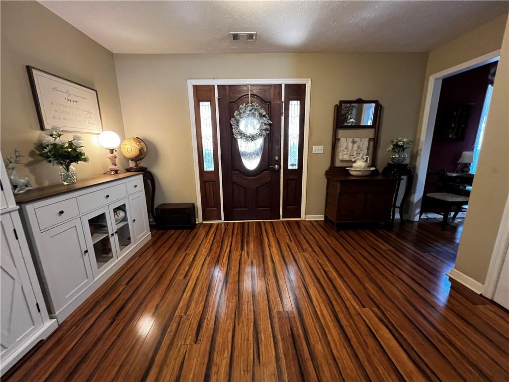 Image 2: A lustrous wood entry floor and elegant front door