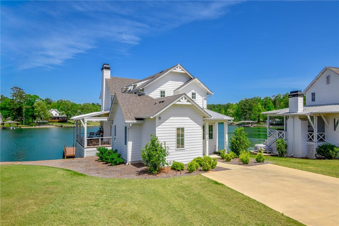 Image 2: This charming lakeside dwelling features crisp whi