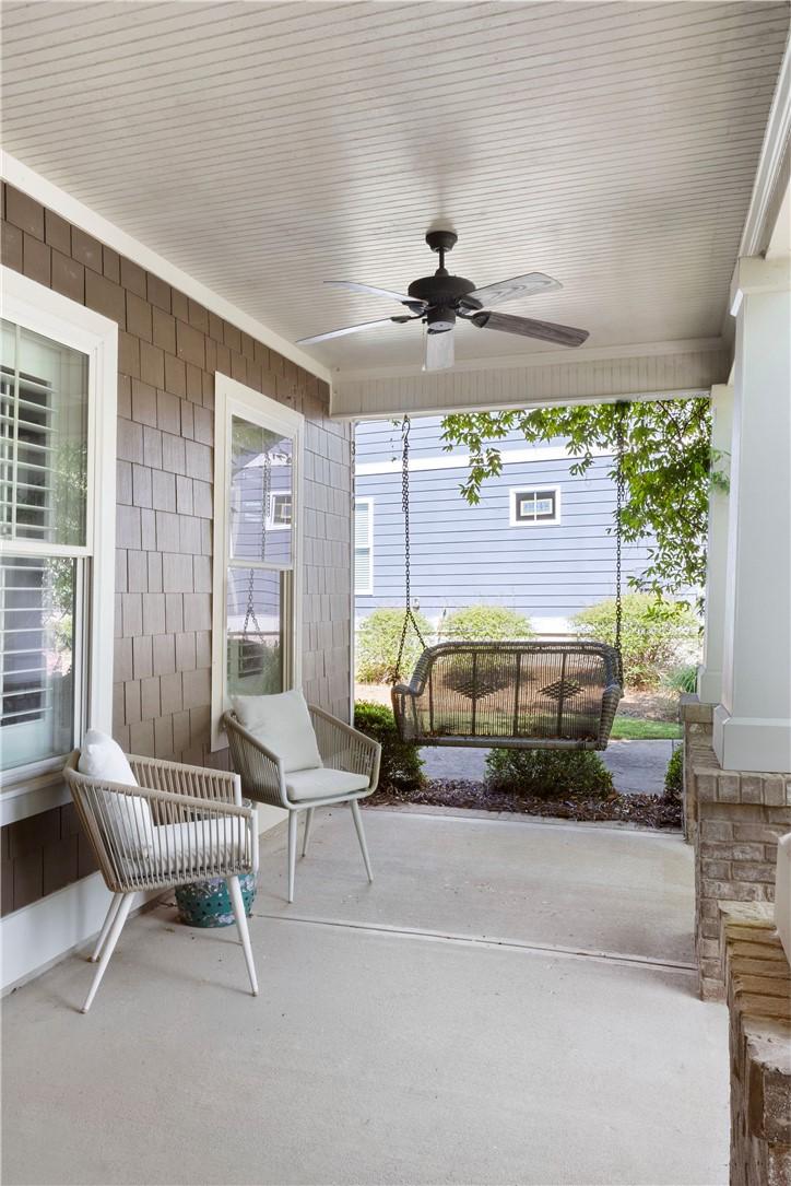 Image 3: A welcoming covered porch with a ceiling fan and a