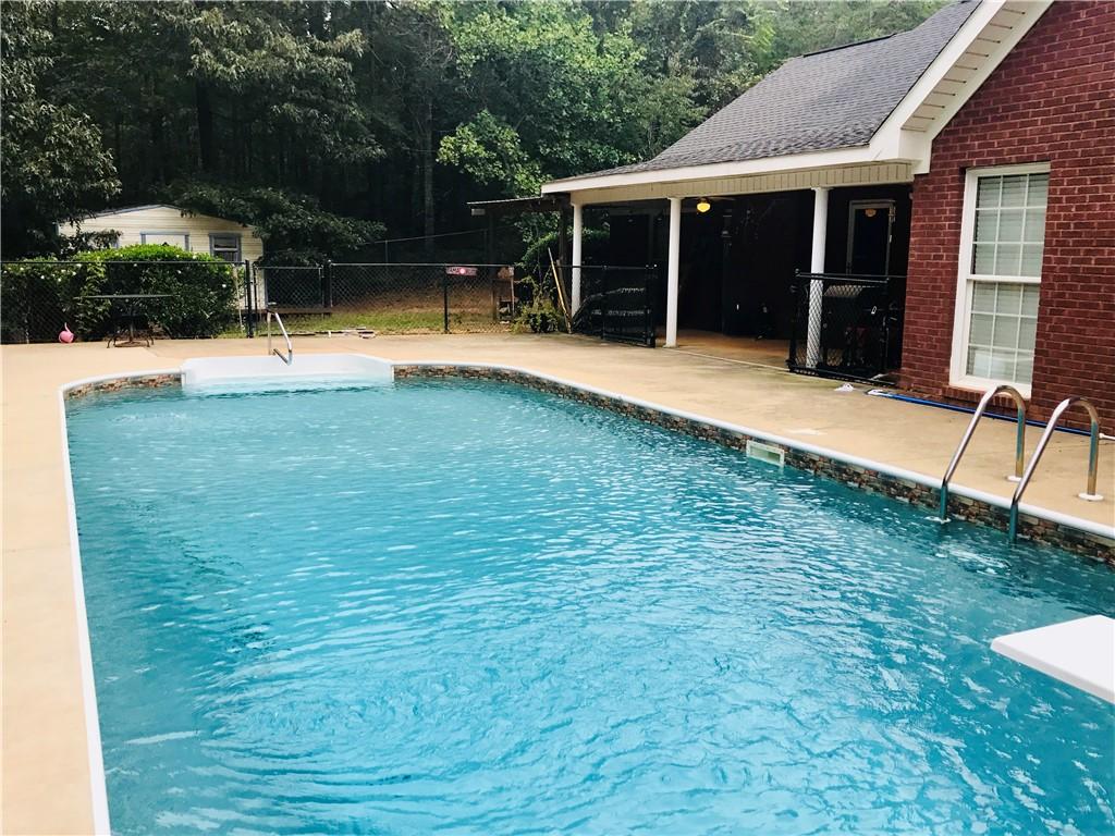 Image 2: A sparkling pool invites relaxation, set against a