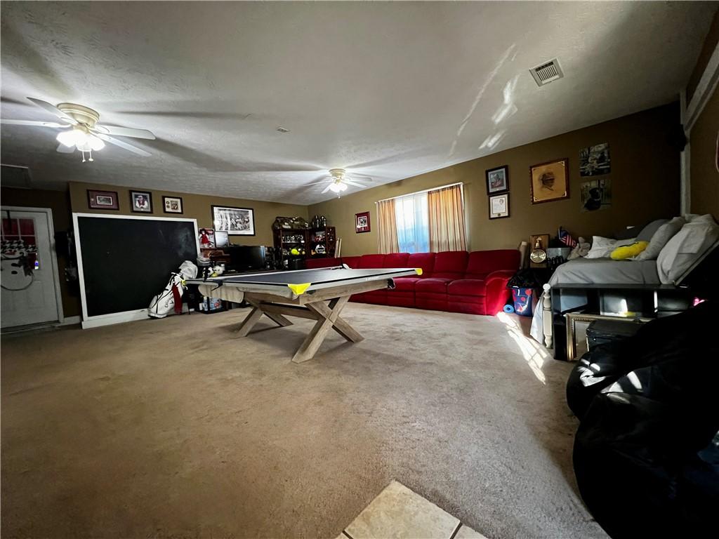 Image 4: An inviting recreation room with abundant space fo