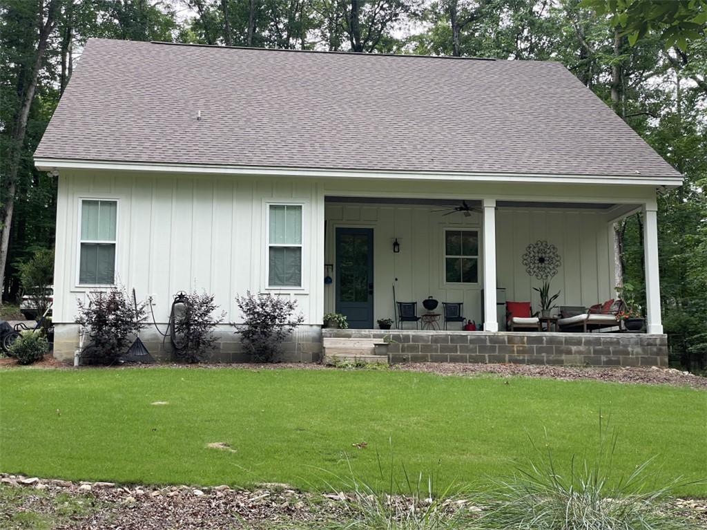 Image 2: A welcoming front porch enhances this charming whi