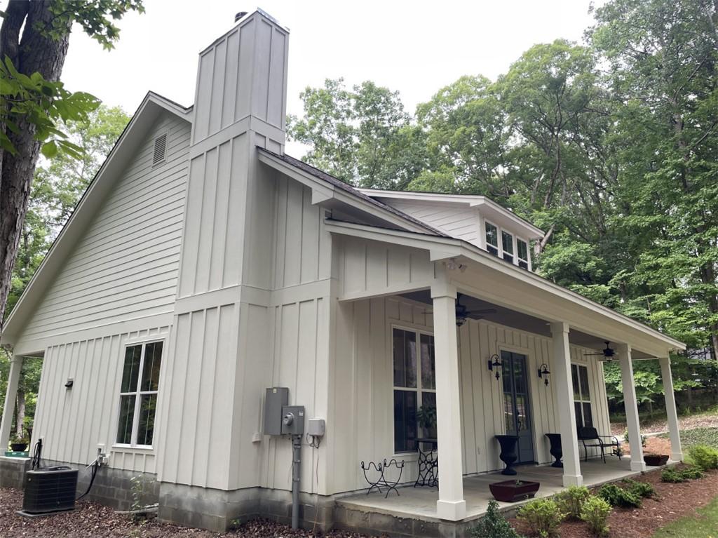 Image 4: A welcoming front porch extends across this charmi