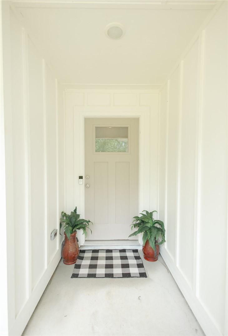 Image 3: A welcoming front entry features white board and b