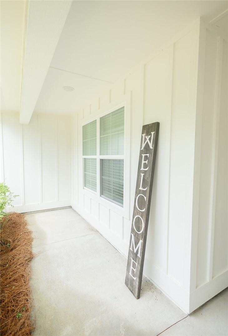 Image 4: A classic covered porch with crisp white siding of
