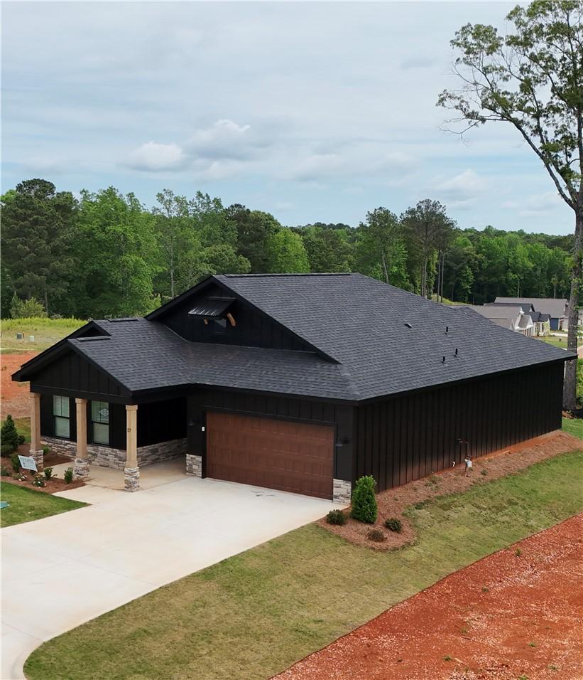 Image 1: This modern residence showcases a striking dark fa