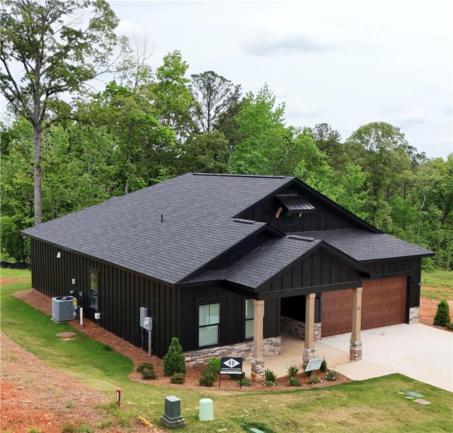 Image 2: This modern home features a striking dark exterior