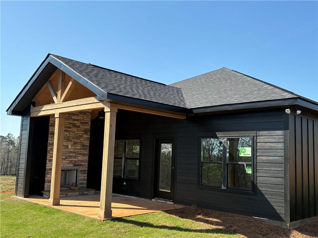 Image 4: This newly constructed home features a stone firep