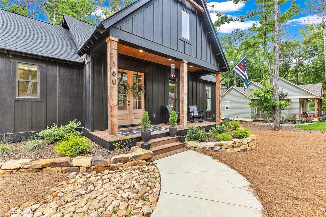 Image 1: Board and batten siding frames a charming porch, o