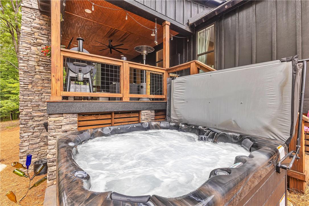 Image 3: Unwind in the bubbling spa on the stone patio, jus