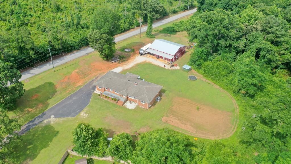 Image 1: Sprawling grounds embrace a classic brick residenc