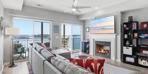 Image 4: Bright living room with sliding glass doors openin