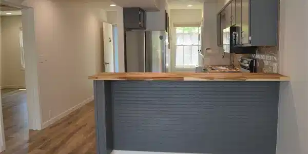 Image 4: The refinished cabinets with accent bar wall, new