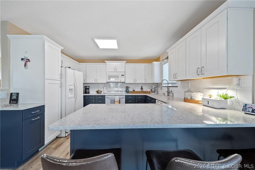 Image 4: The kitchen has been updated with new cabinetry, c