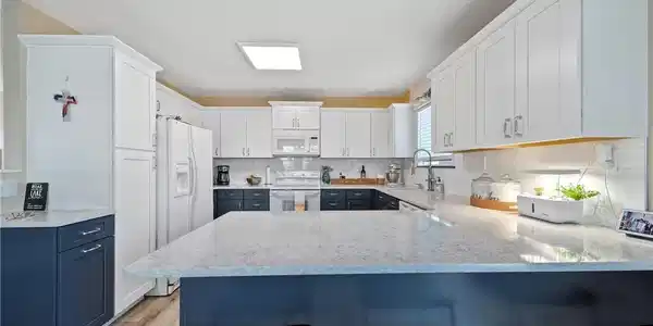 Image 4: The kitchen has been updated with new cabinetry, c