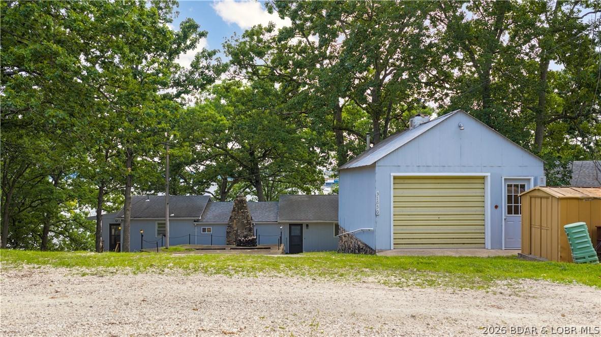 Image 4: Front of home w/ detached garage + extra parking