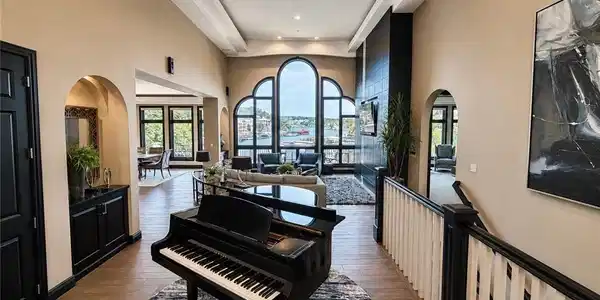 Image 2: Dramatic entry opens to soaring ceilings, arched w