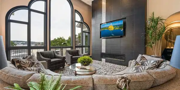 Image 3: Great room framed by dramatic arched windows overl