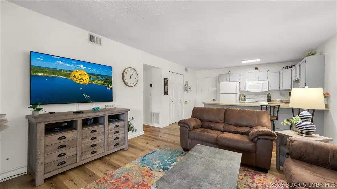 Image 1: Stunning open-concept living room featuring crisp