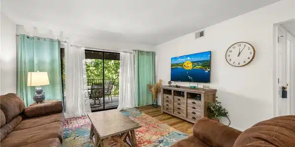 Image 3: Spacious living room featuring large sliding glass