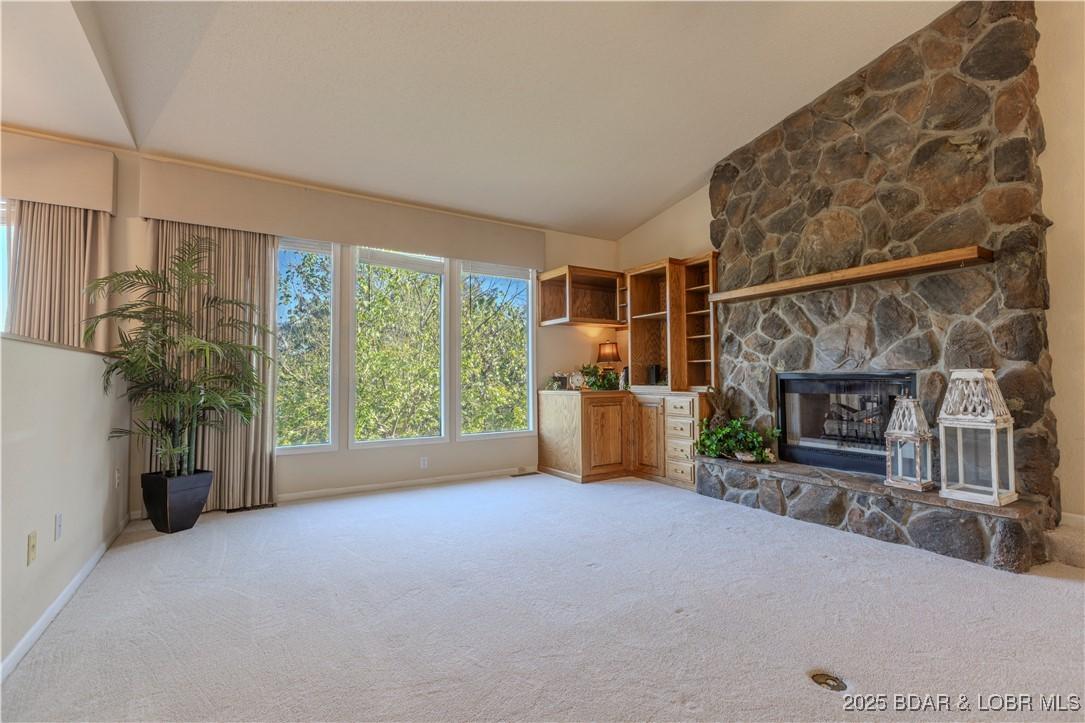 Image 4: Big windows with a cozy stone fireplace in a sunke