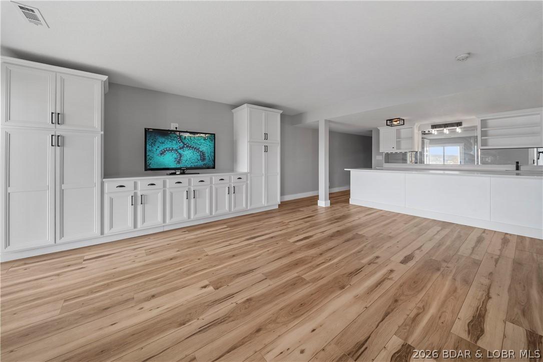 Image 3: Full Basement w/ Custom Cabinetry & Kitchen