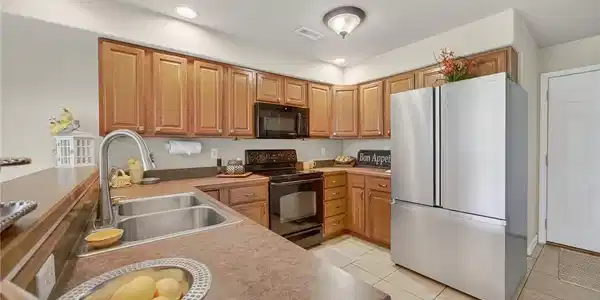 Image 3: Spacious Kitchen w/ Breakfast Bar & Stainless-Stee