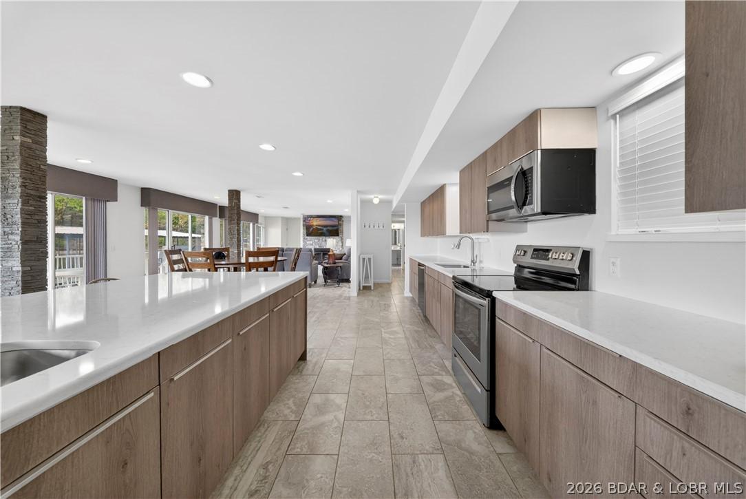 Image 3: Large open kitchen seamlessly connects to great ro