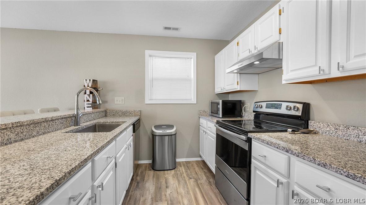 Image 4: Updated kitchen with granite and stainless applian